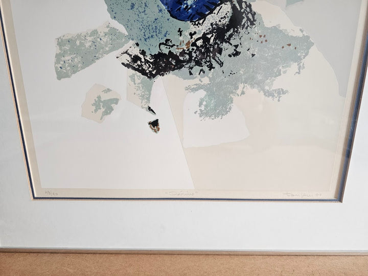 Framed abstract artwork with blue and black elements on a light background