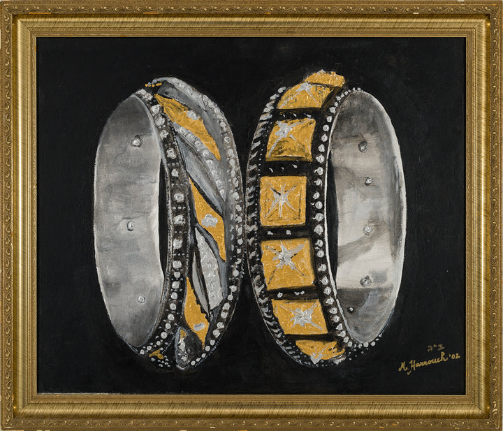 Artistic depiction of two ornate rings with gold and silver design on a black background, framed in gold.