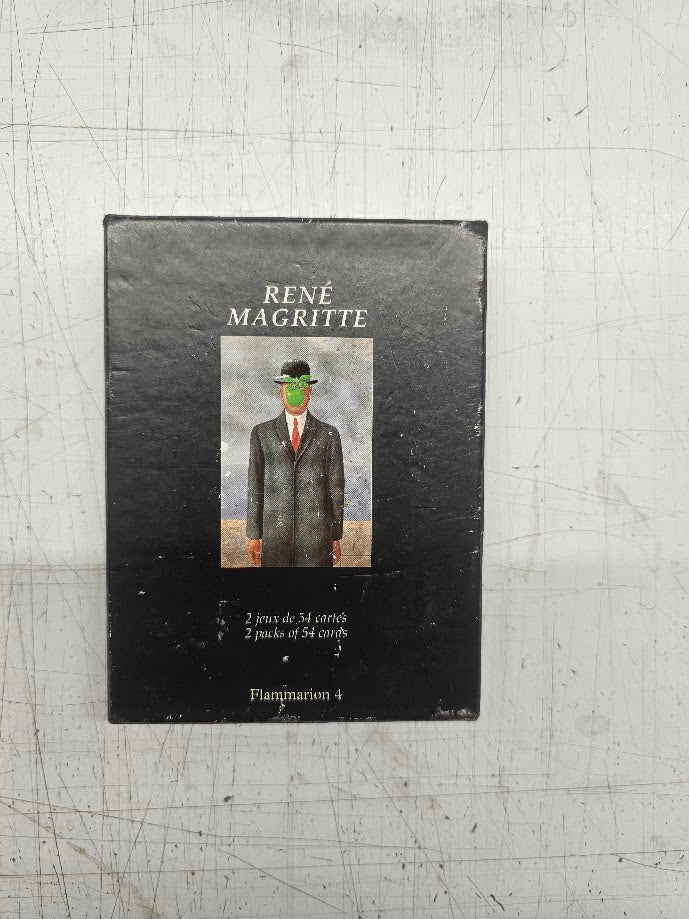 Book cover of René Magritte with a painting of a man in a suit on a metal surface