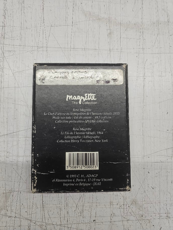 Back of a book with text and a barcode on a textured gray surface