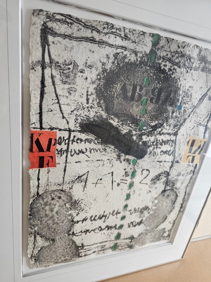 Abstract art piece with text and symbols on a textured surface