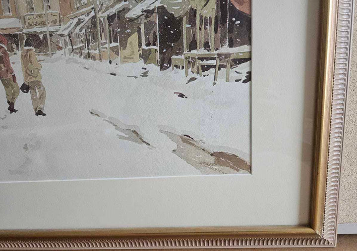 Framed artwork of a snowy street scene with people and birds.