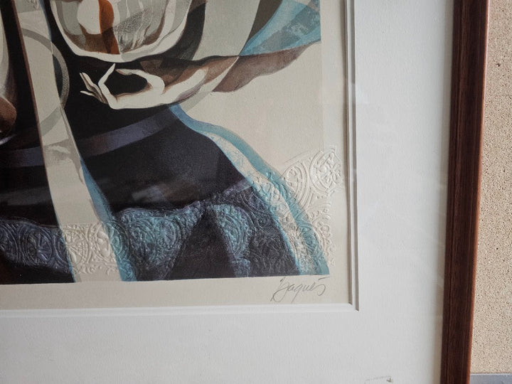 Framed abstract artwork with textured elements on a textured wall.