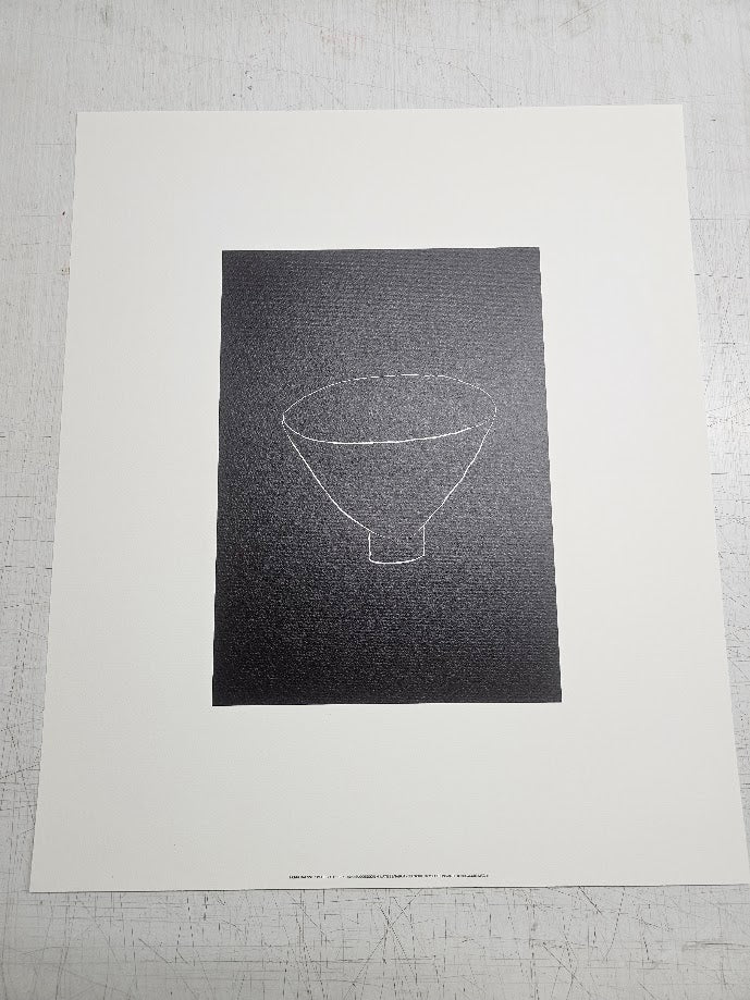 Black and white abstract art print on a textured gray surface