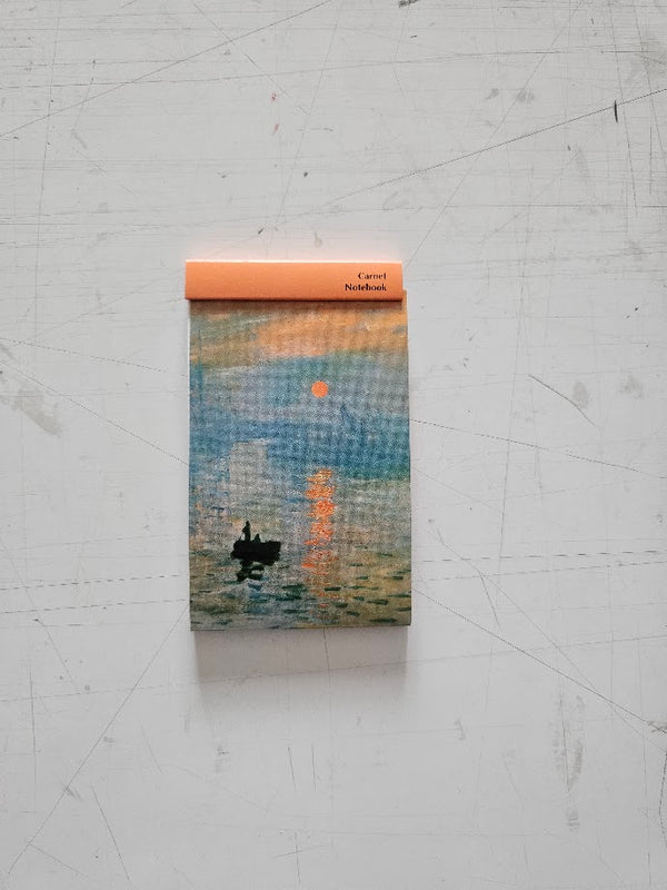 Notebook with a artistic cover design on a textured surface
