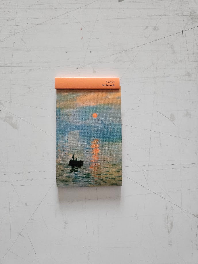 Notebook with a artistic cover design on a textured surface