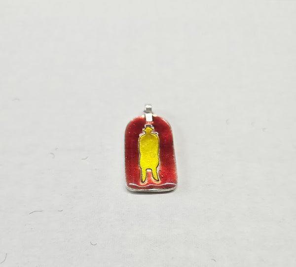 Pendant with red and gold design on a light gray background