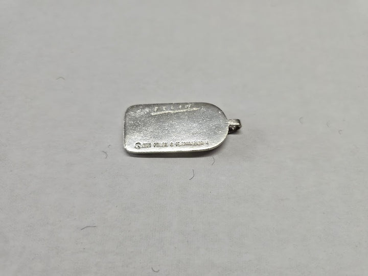 Silver metal object on a gray background